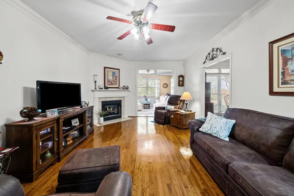 a living room with furniture fireplace and window