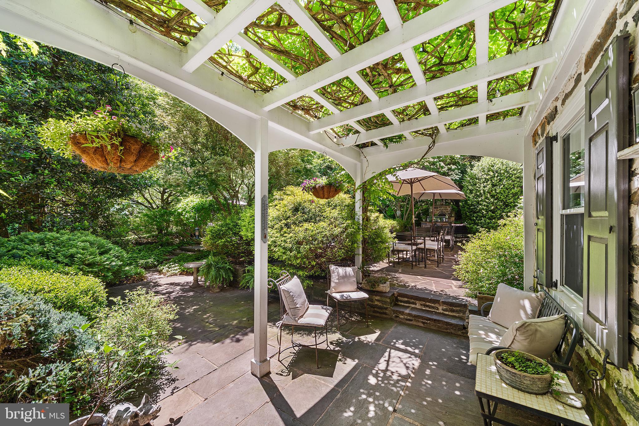 311 Millbank Road Bryn Mawr, PA 19010 - Photo 40 of 54 a view of a patio with couches table and chairs and potted plants
