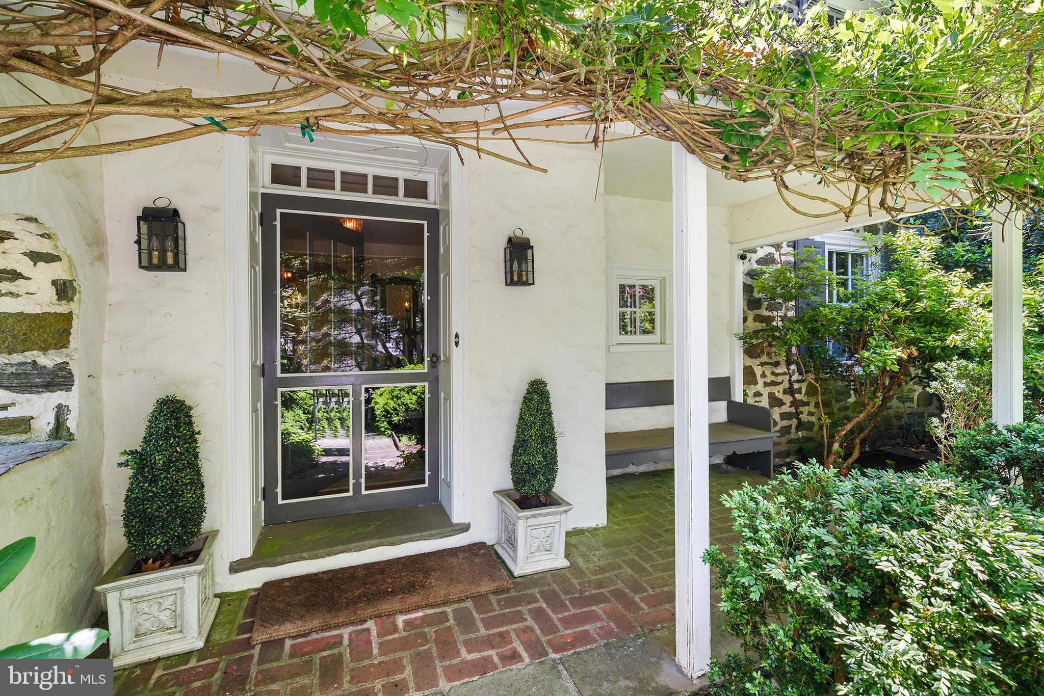311 Millbank Road Bryn Mawr, PA 19010 - Photo 41 of 54 a front view of a house with garden