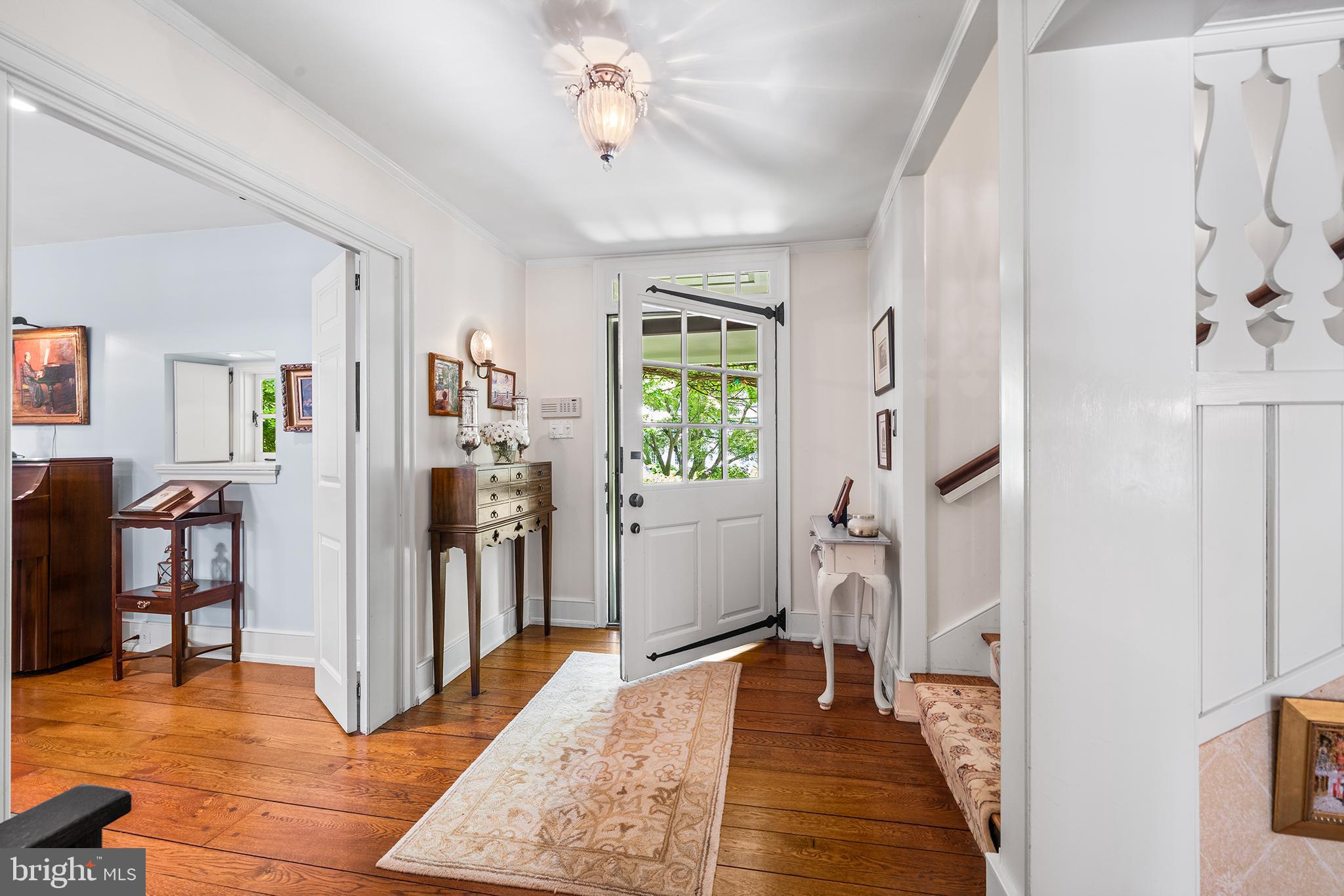 311 Millbank Road Bryn Mawr, PA 19010 - Photo 6 of 54 a view of a hallway with furniture and a livingroom