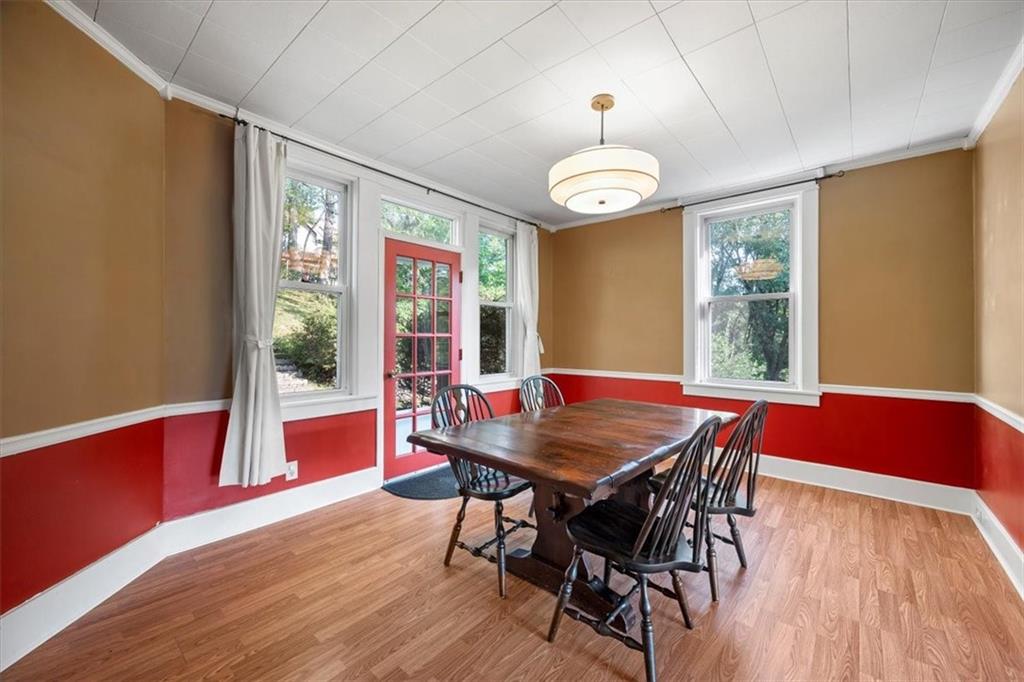 227 Elmore Road Pittsburgh, PA 15221 - Photo 13 of 50 a view of a dining room with furniture wooden floor and chandelier