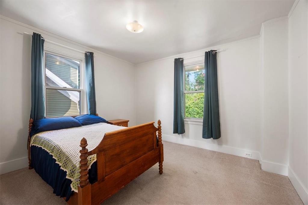 227 Elmore Road Pittsburgh, PA 15221 - Photo 23 of 50 a bed sitting in a bedroom next to a window