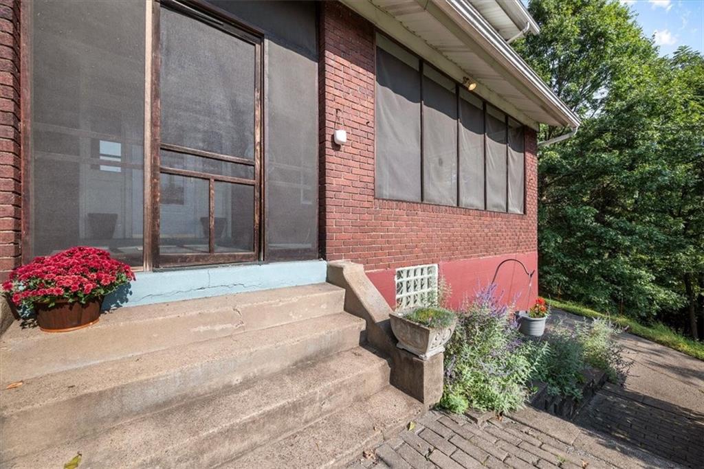 227 Elmore Road Pittsburgh, PA 15221 - Photo 3 of 50 a front view of a house with a garden