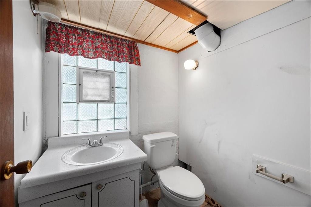227 Elmore Road Pittsburgh, PA 15221 - Photo 36 of 50 a bathroom with a sink a toilet and a mirror
