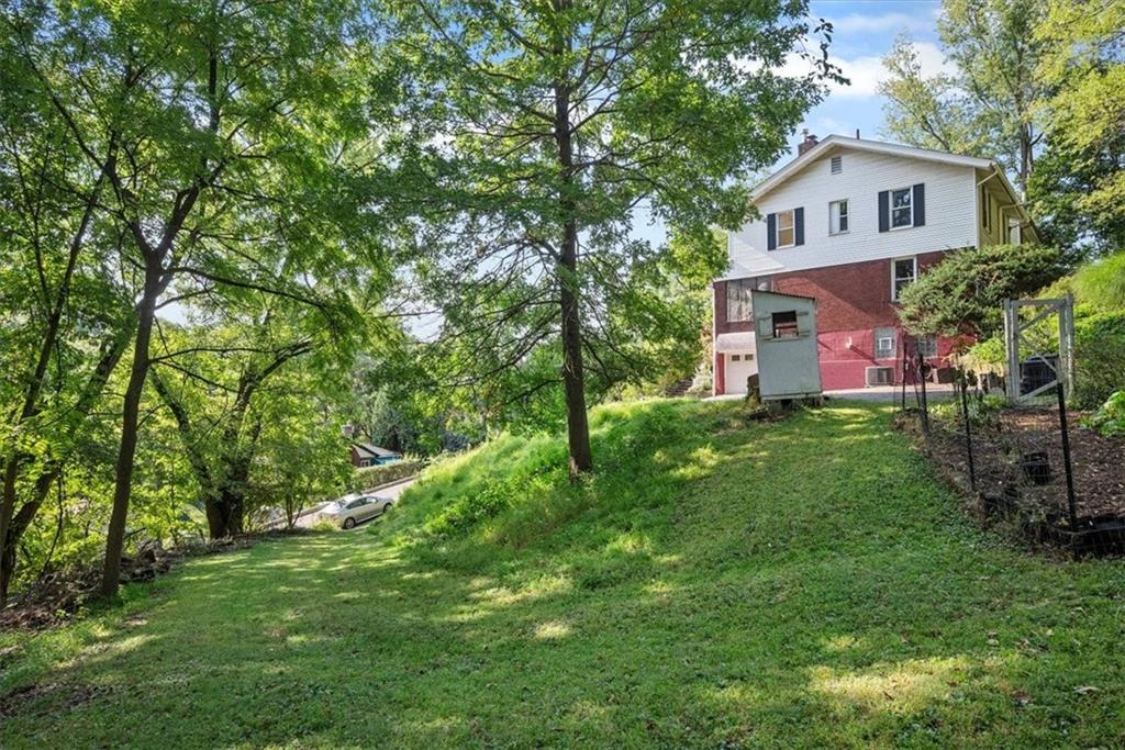 227 Elmore Road Pittsburgh, PA 15221 - Photo 43 of 50 a front view of a house with a yard and a tree