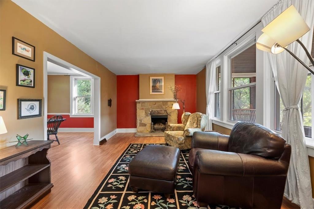 227 Elmore Road Pittsburgh, PA 15221 - Photo 9 of 50 a living room with furniture a large window and a fireplace
