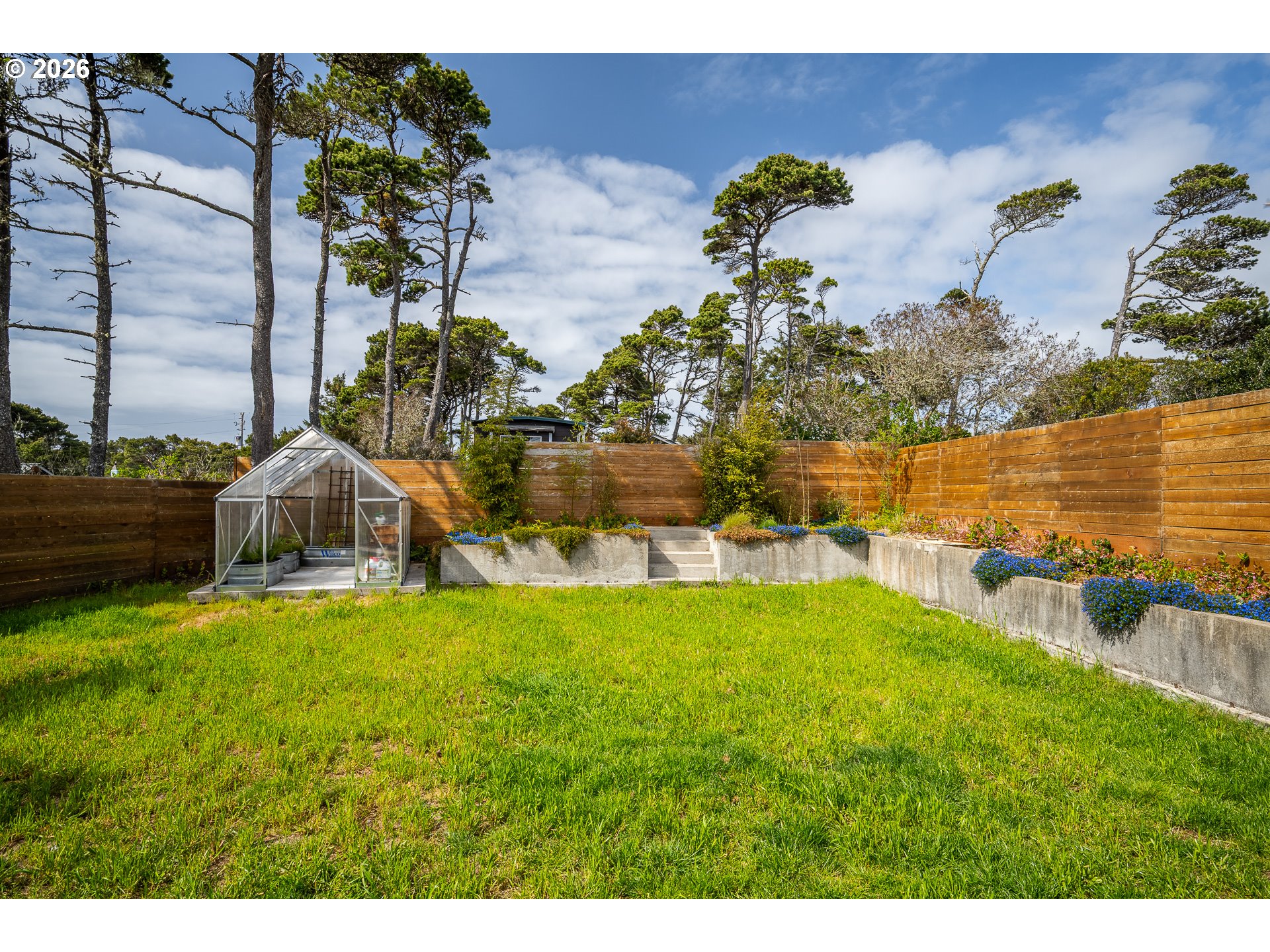 4595 Blanco Street Florence, OR 97439 - Photo 25 of 28 a backyard of a house with lots of green space
