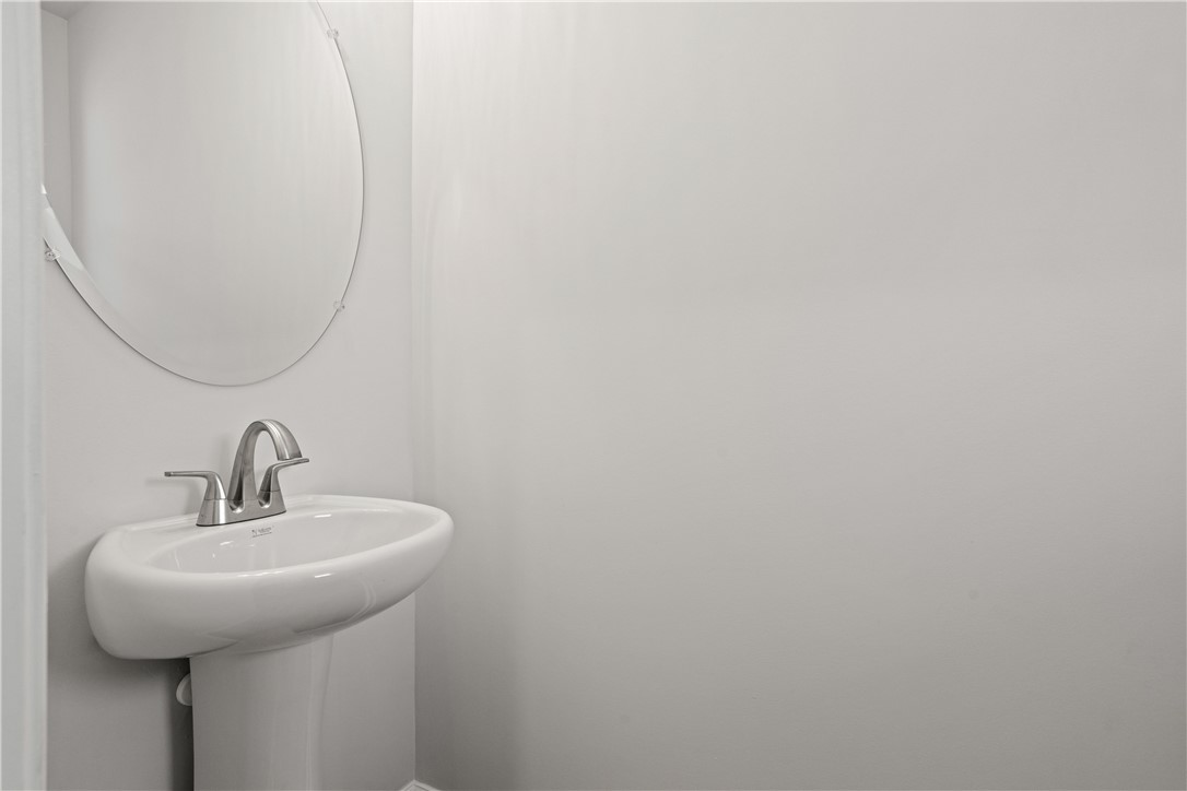 629 Sweetspire Trail, Unit 149 Seneca, SC 29678 - Photo 9 of 30 A sleek pedestal sink and mirror furnish this compact, functional powder room.