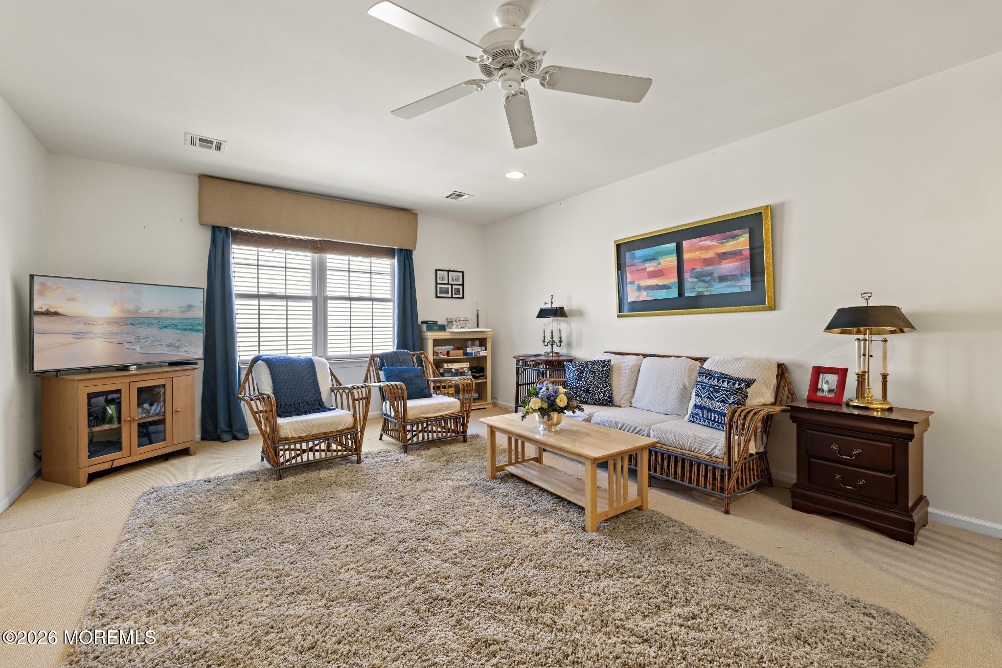23 Congressional Road Jackson, NJ 08527 - Photo 37 of 65 a living room with furniture and a flat screen tv