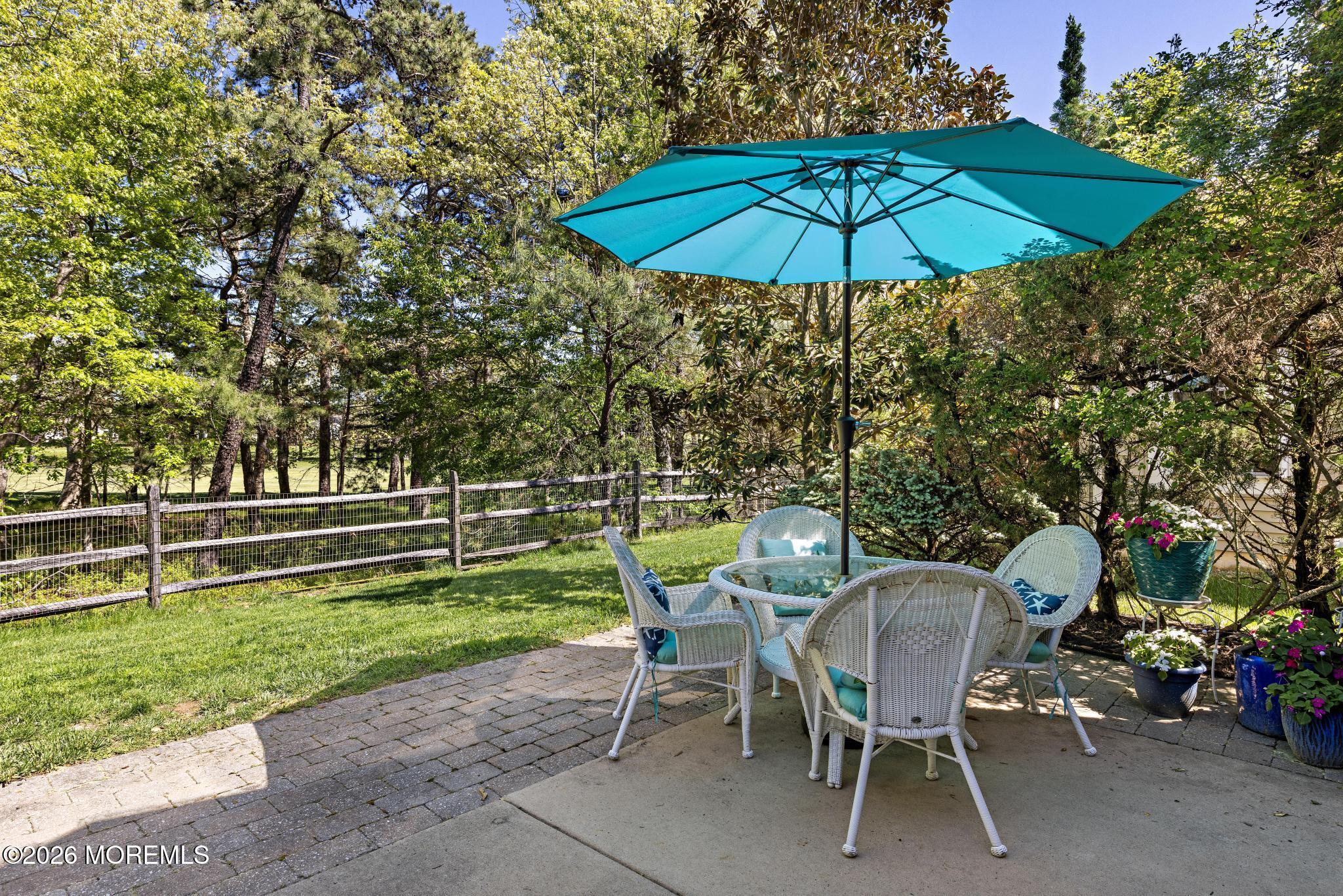 23 Congressional Road Jackson, NJ 08527 - Photo 48 of 65 a view of a chairs and table under an umbrella in backyard