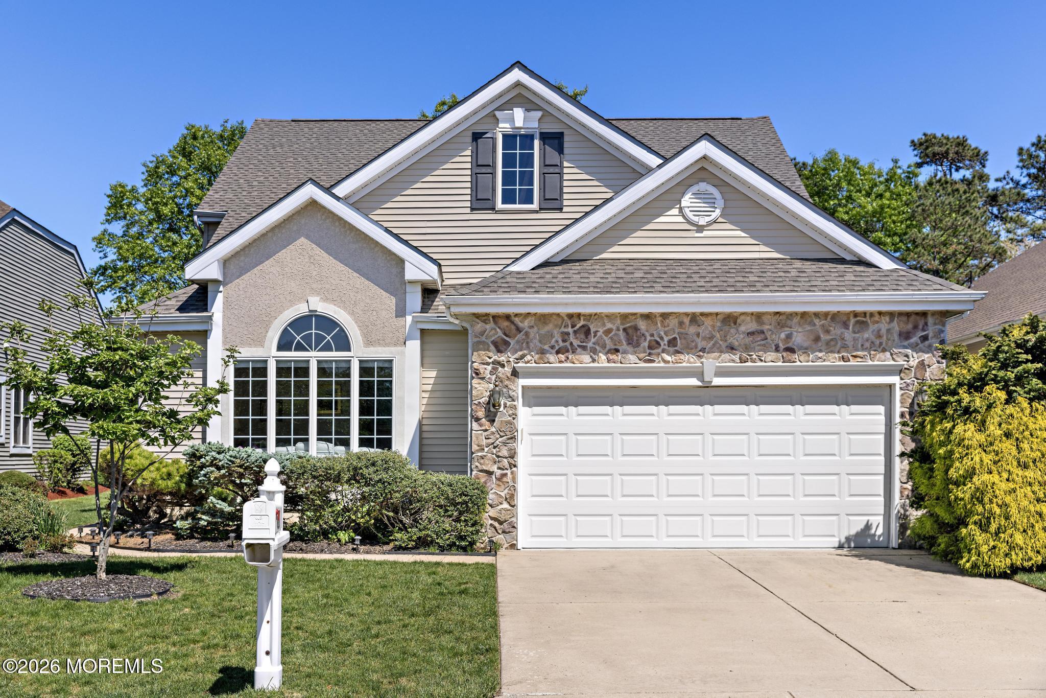 23 Congressional Road Jackson, NJ 08527 - Photo 6 of 65 a front view of a house with a yard and garage