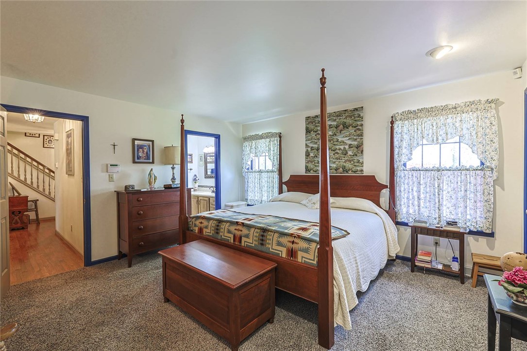 1757 Phillips Road Lebanon, OH 45036 - Photo 15 of 51 This spacious bedroom offers a tranquil retreat, featuring an inviting ensuite bathroom for ultimate convenience.