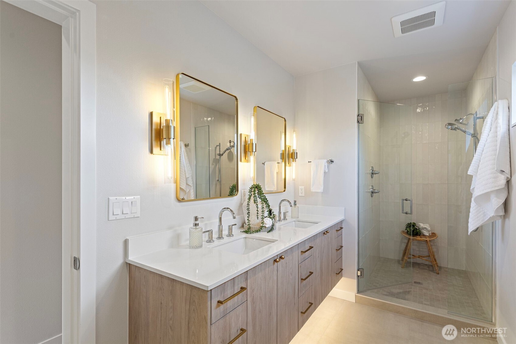 1127 Northwest 58th Street, Unit B Seattle, WA 98107 - Photo 26 of 30 a bathroom with a double vanity sink mirror double and shower
