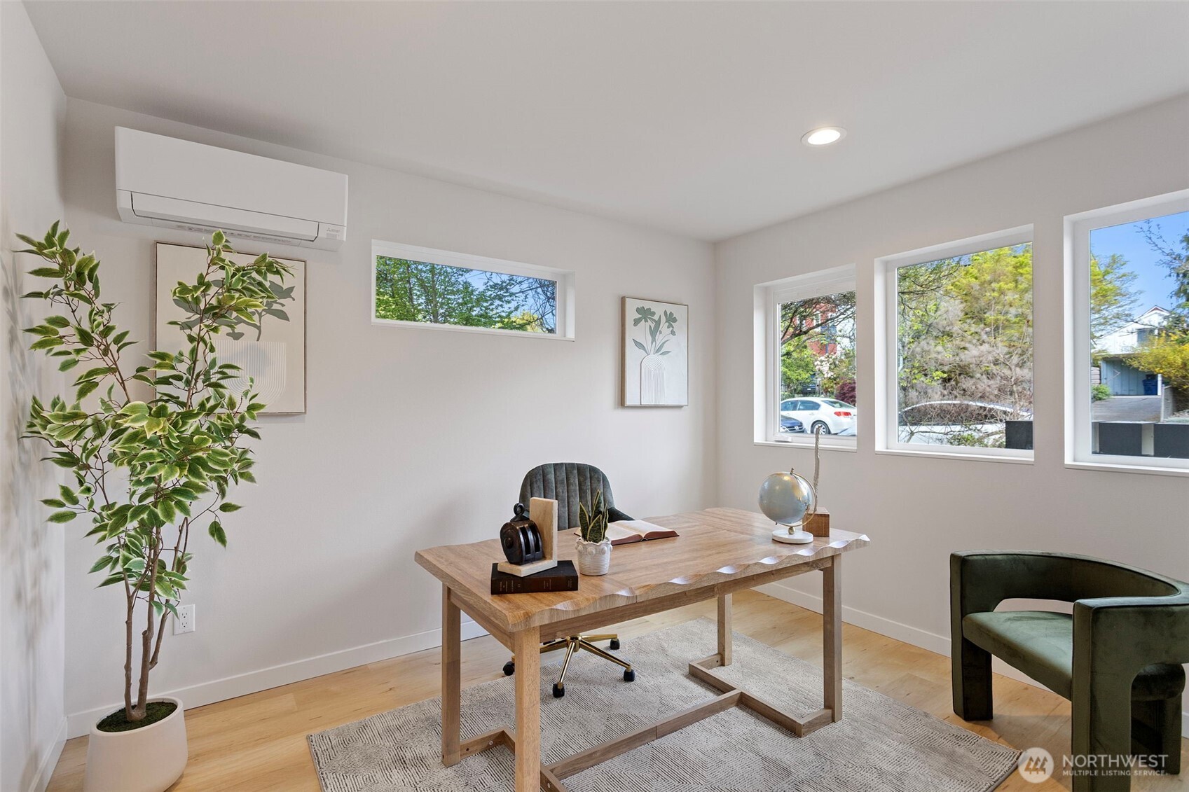1127 Northwest 58th Street, Unit B Seattle, WA 98107 - Photo 4 of 30 a view of a workspace with a window and a potted plant