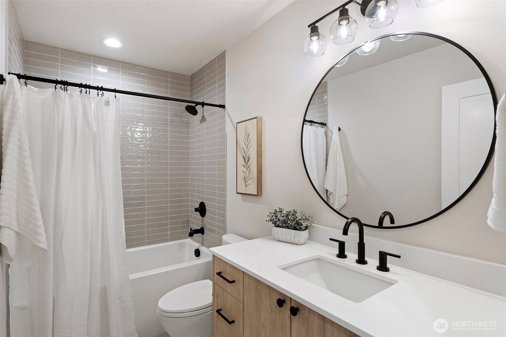 1127 Northwest 58th Street, Unit B Seattle, WA 98107 - Photo 6 of 30 a bathroom with a sink a toilet and a mirror