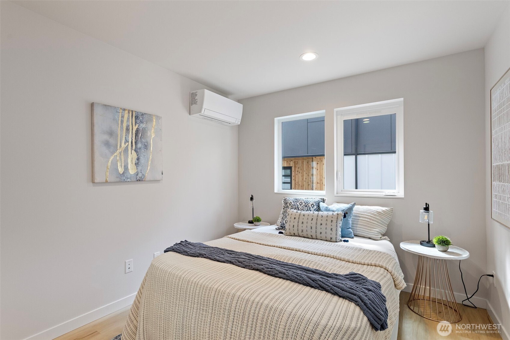 1127 Northwest 58th Street, Unit B Seattle, WA 98107 - Photo 8 of 30 a bedroom with a bed and a painting on the wall