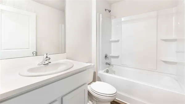 a bathroom with a sink a toilet and a bathtub