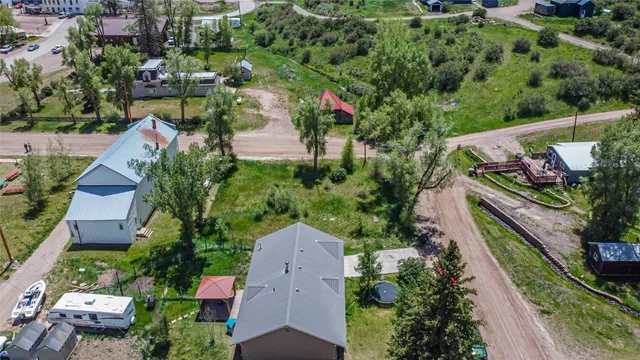 an aerial view of a house with a garden and lake view