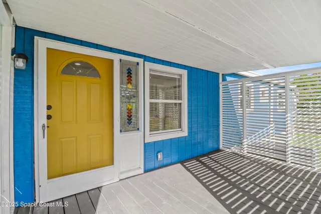 a view of a livingroom with wooden floor and windows