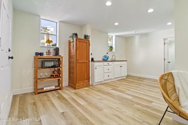a bedroom with a bed and a refrigerator