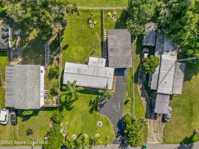 an aerial view of residential house with outdoor space and swimming pool