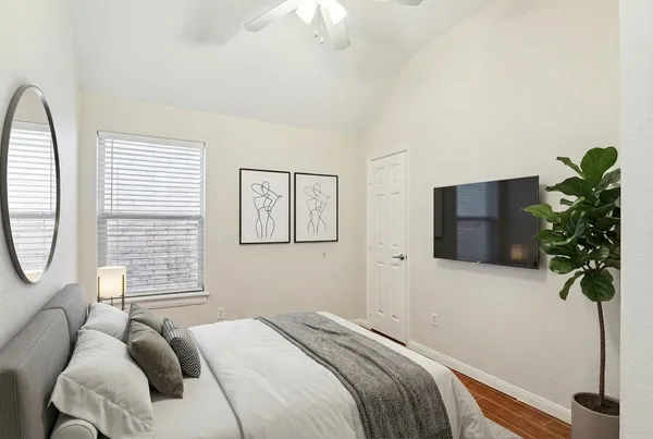 a bedroom with a bed a chandelier and a potted plant