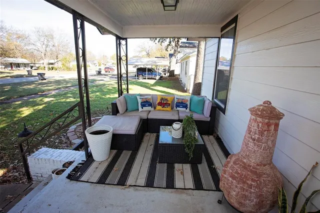 a living room with furniture and floor to ceiling windows