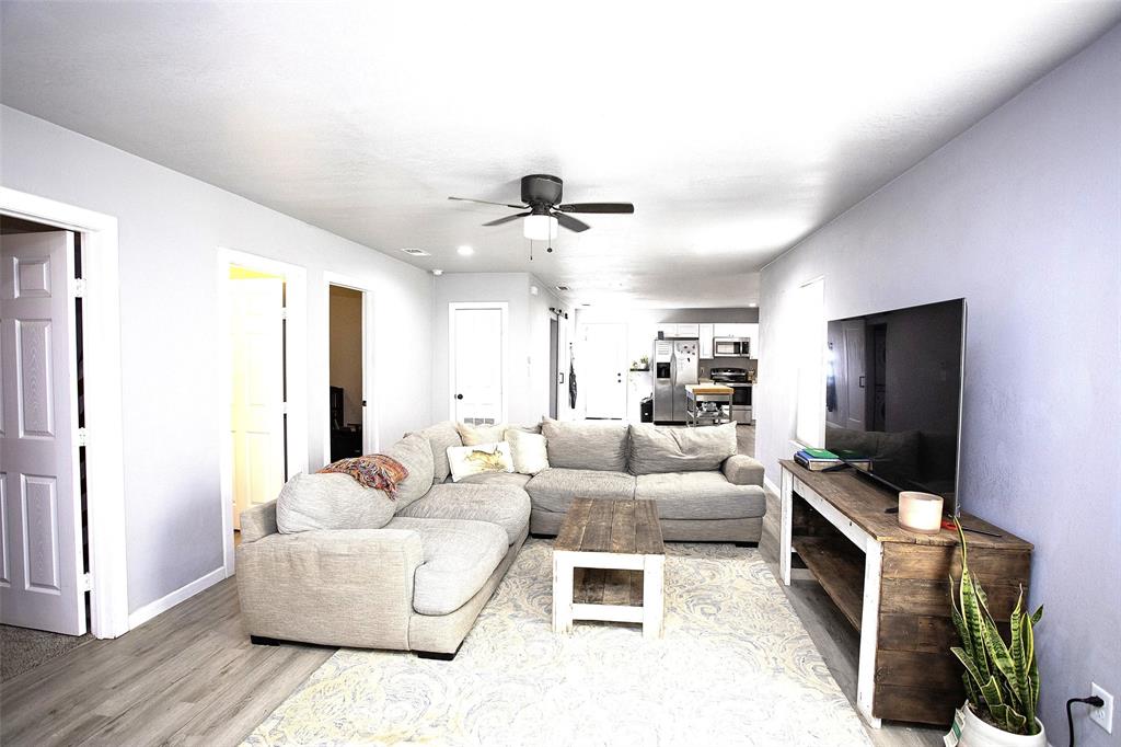 723 Plum Street Graham, TX 76450 - Photo 4 of 20 a living room with furniture and a flat screen tv