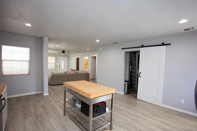 a room with pool table and window