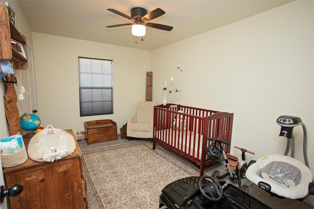 723 Plum Street Graham, TX 76450 - Photo 10 of 20 a bedroom with furniture and a wooden floor