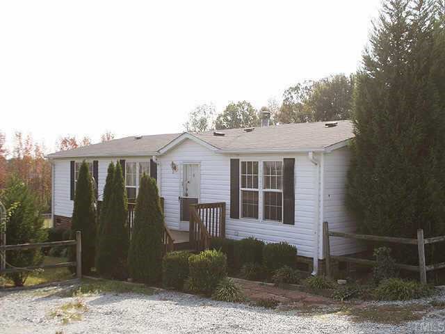 51 Kermit Duncan Road Timberlake, NC 27583 - Photo 1 of 6 a front view of a house with garden