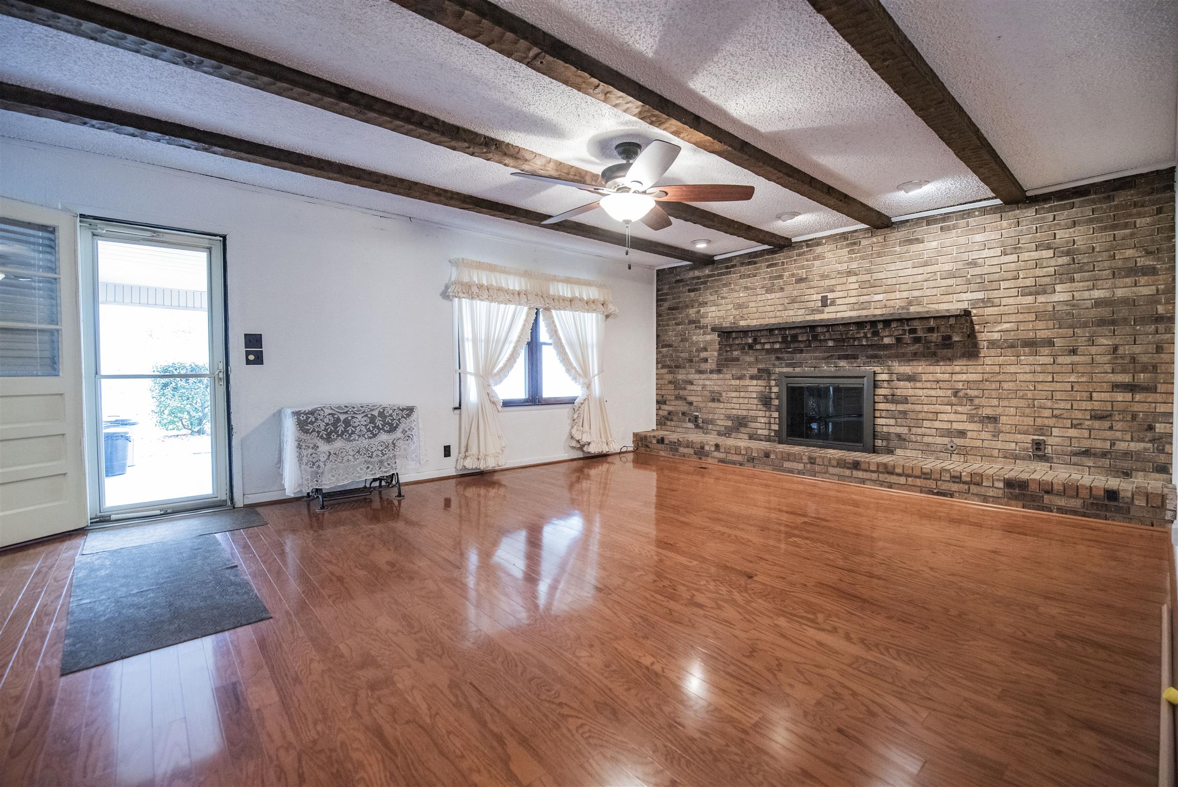 925 Alford Road Murfreesboro, TN 37129 - Photo 27 of 30 a view of empty room with wooden floor and fireplace