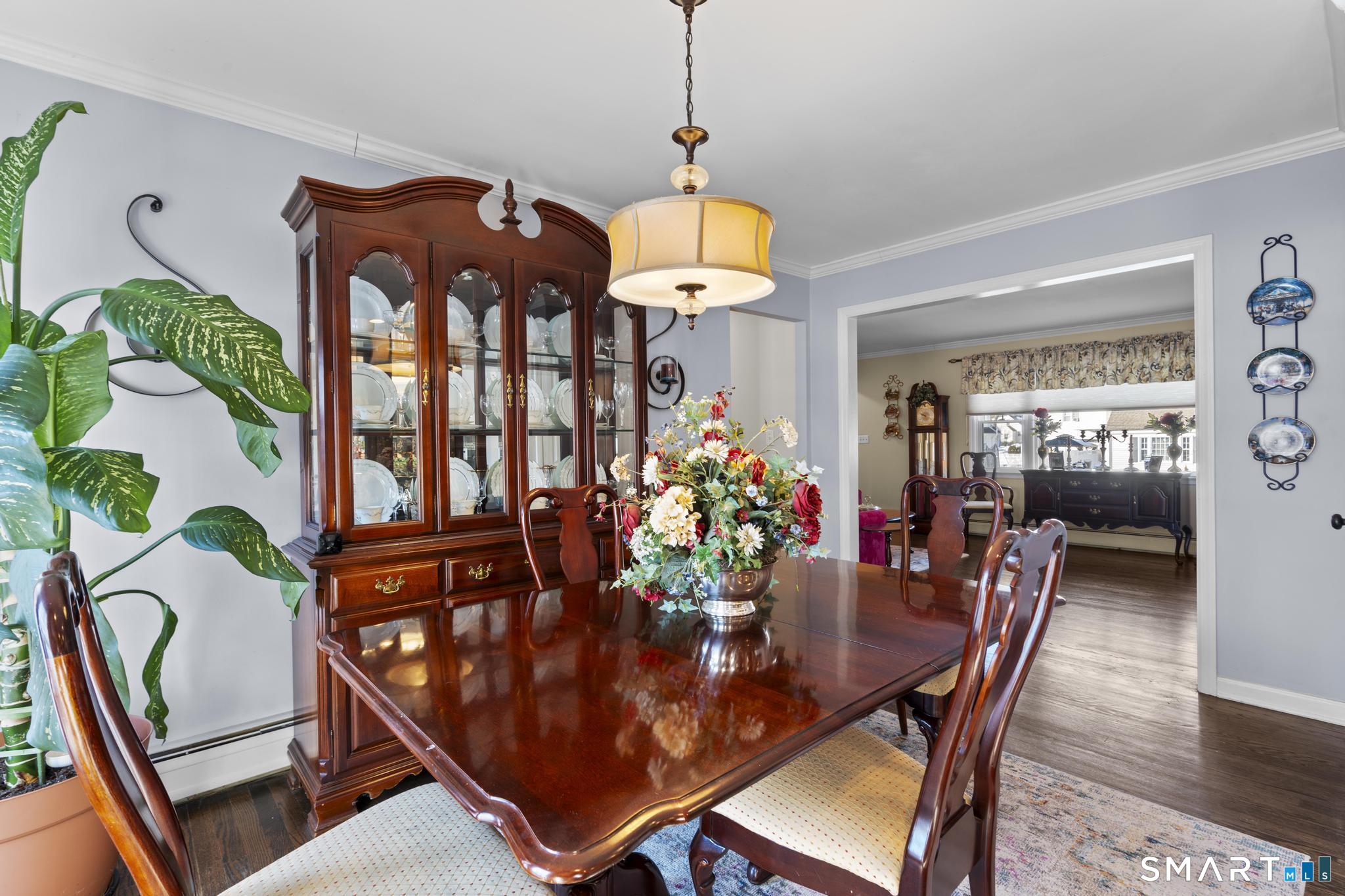 710 East Main Street Stratford, CT 06614 - Photo 11 of 34 a dining room with furniture potted plants and wooden floor