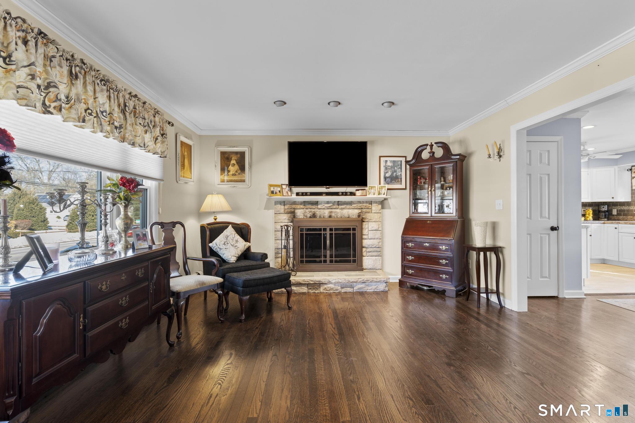 710 East Main Street Stratford, CT 06614 - Photo 14 of 34 a living room with furniture a flat screen tv and a fireplace