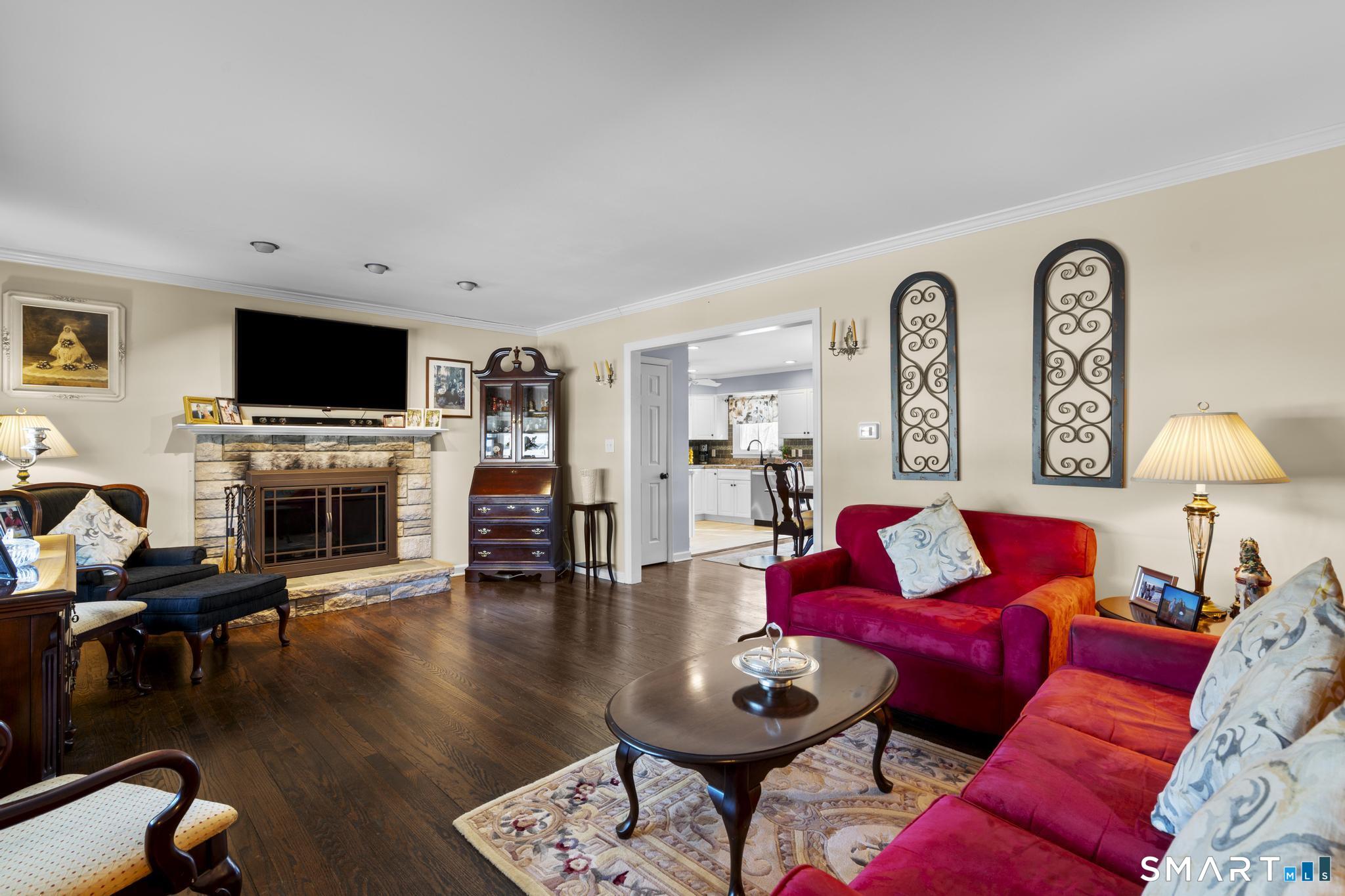 710 East Main Street Stratford, CT 06614 - Photo 15 of 34 a living room with furniture a fireplace and a flat screen tv