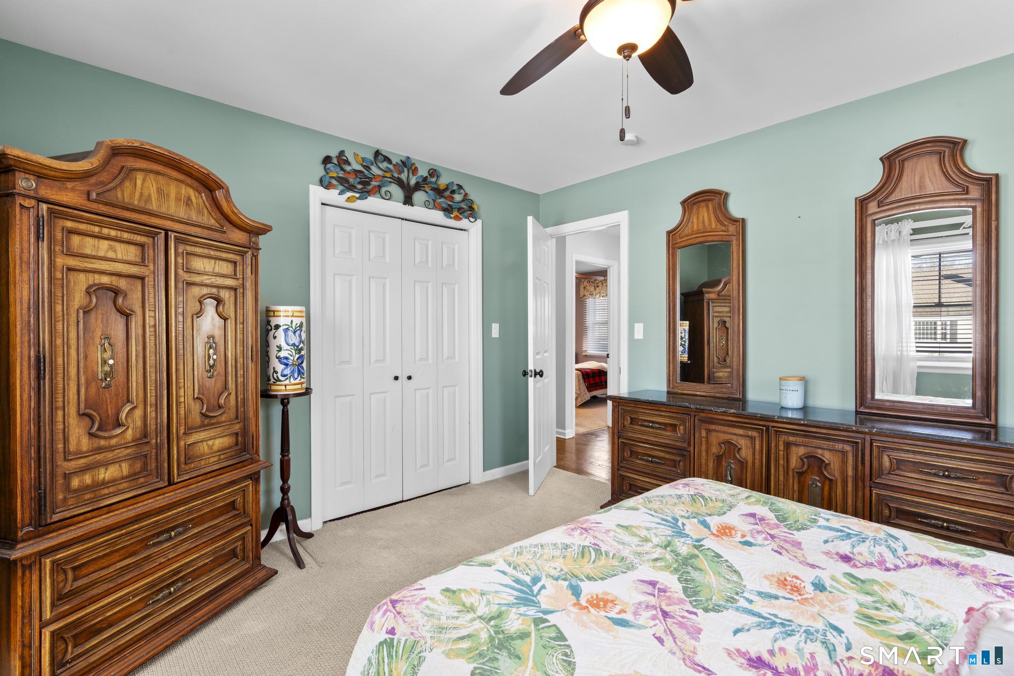 710 East Main Street Stratford, CT 06614 - Photo 17 of 34 a bedroom with a bed and a dresser