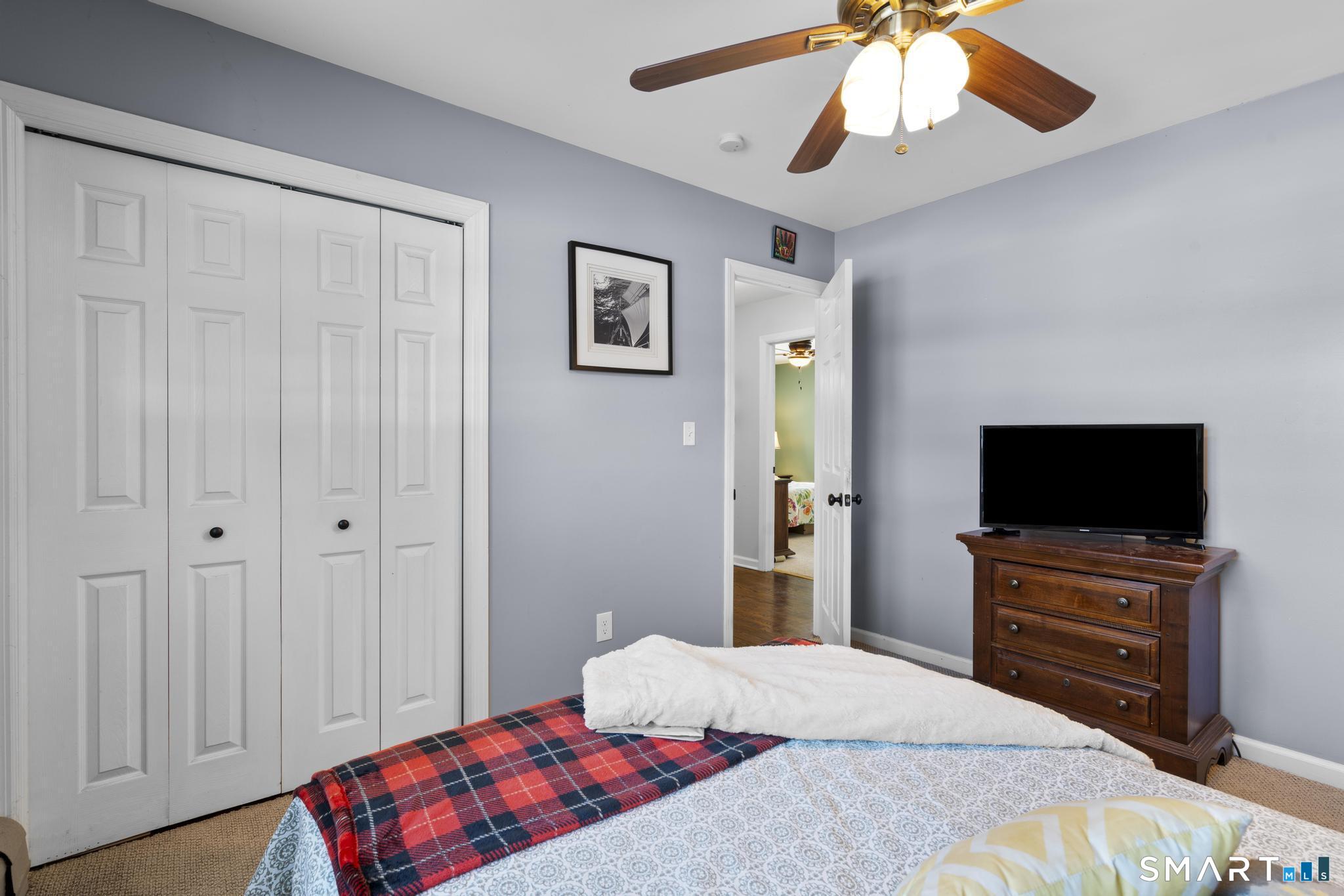 710 East Main Street Stratford, CT 06614 - Photo 23 of 34 a bedroom with a bed and a flat screen tv