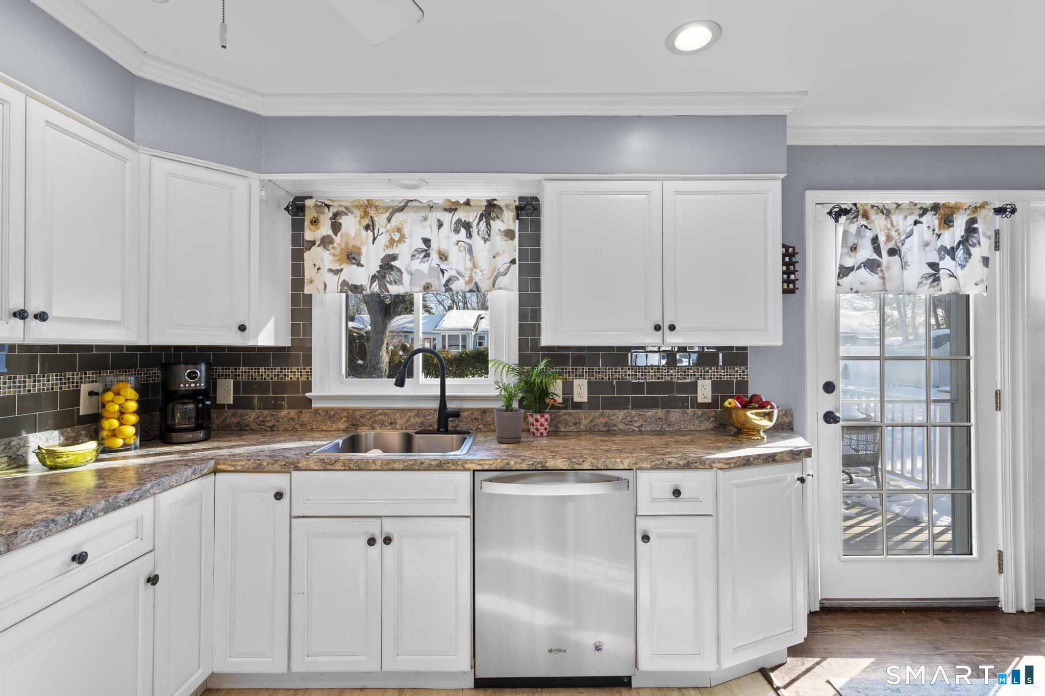 710 East Main Street Stratford, CT 06614 - Photo 6 of 34 a kitchen with white cabinets and window