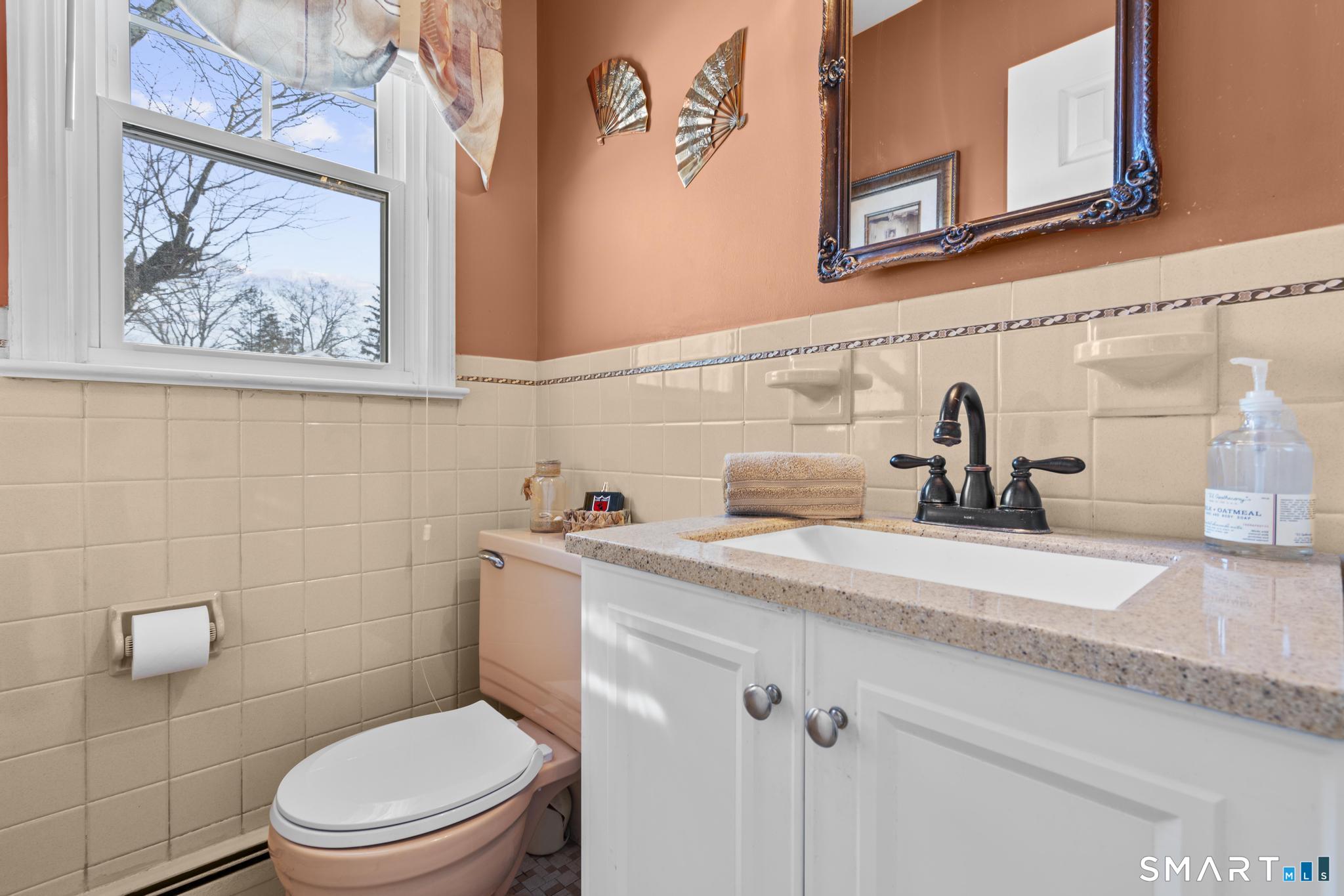 710 East Main Street Stratford, CT 06614 - Photo 9 of 34 a bathroom with a toilet sink and mirror