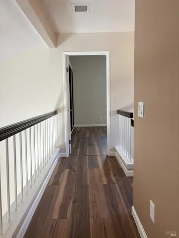 a bathroom with a granite countertop toilet sink and mirror