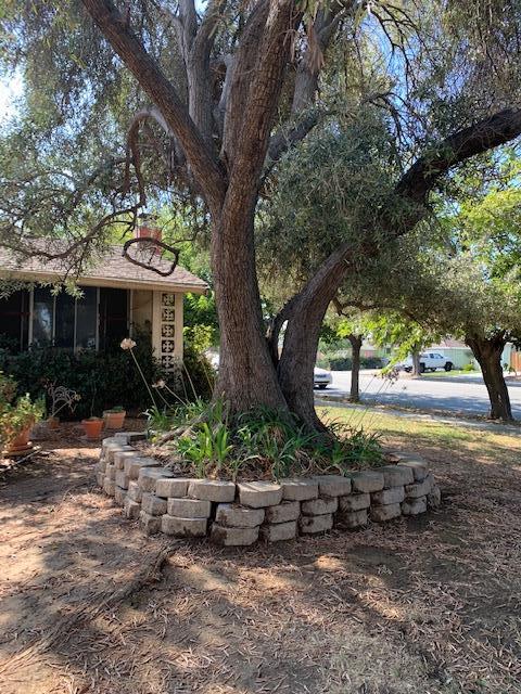 a view of a house with backyard and sitting area