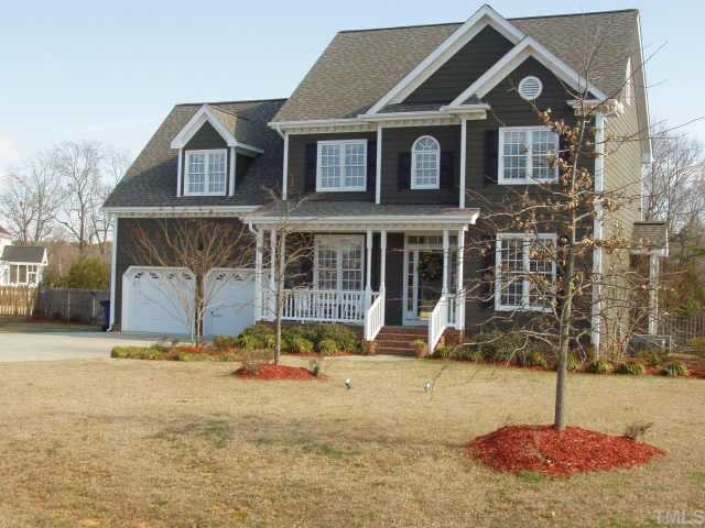 1613 Kendall Hill Road Willow Spring, NC 27592 - Photo 1 of 10 a front view of a house with a yard