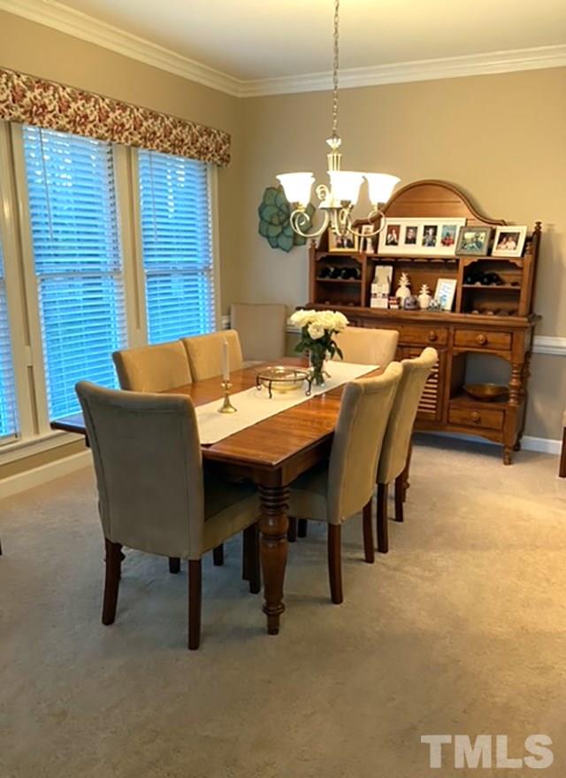 2017 Treverton Place Raleigh, NC 27609 - Photo 5 of 6 a view of a dining room with furniture and a chandelier