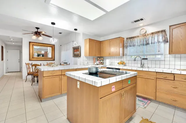 a kitchen with stainless steel appliances granite countertop a sink counter space cabinets and a large window