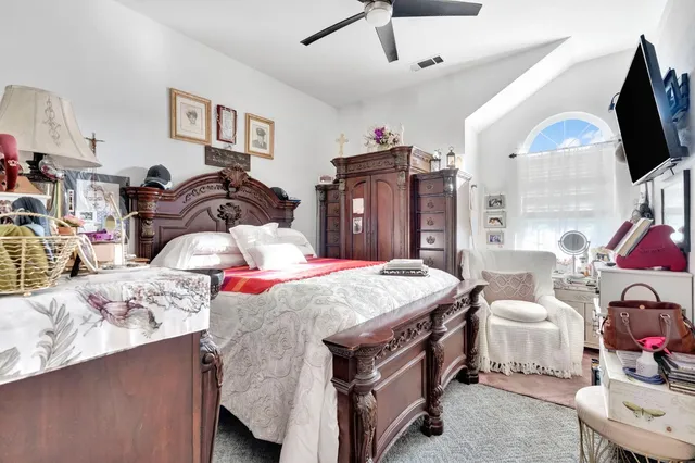 a bedroom with bed and flat screen tv