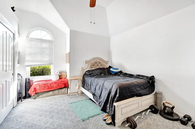 a bedroom with a bed and window