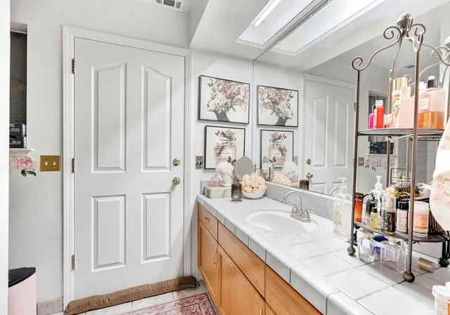 a bathroom with double vanity and a sink