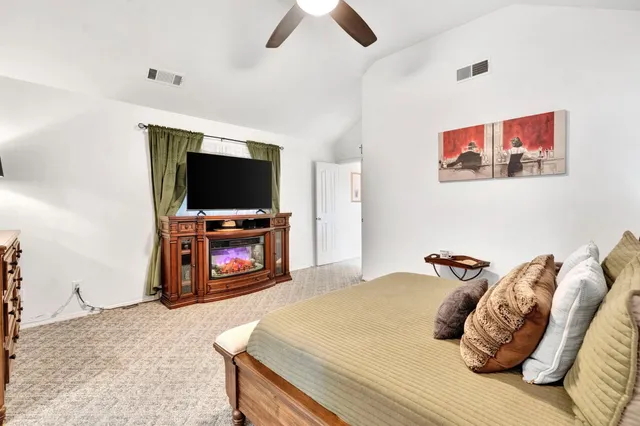 a bedroom with a bed and a television