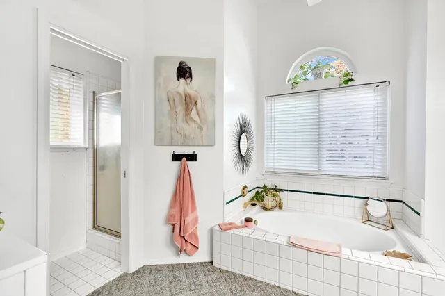 a bathroom with a bathtub and a window