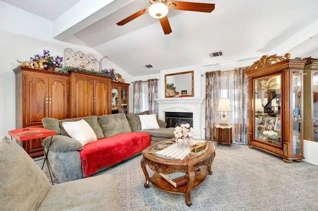 a living room with furniture and a fireplace